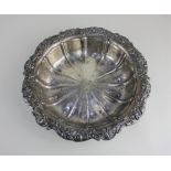 A sterling silver circular bowl with floral scroll border, central engraved initial, 10.3oz 26cm