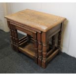 A nest of three rectangular oak side tables on turned and block supports, 61cm