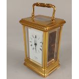 A gilt metal cased carriage clock, white enamel dial with Roman numerals and inscribed 'St James