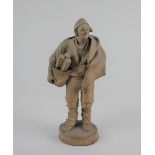 A pottery figure of a woodcutter 19cm high