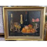 Kathleen Hollins, still life of a bowl of fruit with wine bottles, glasses and roses in a vase,