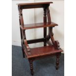 A set of Victorian style mahogany library steps, with three steps on scrolling supports on turned