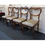 A set of four Victorian rosewood dining chairs open kidney shaped backs with drop in seats on turned