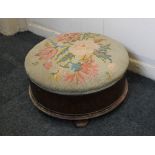A Victorian rosewood tapestry topped circular footstool on four button feet, 43cm
