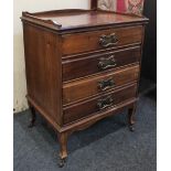 A small mahogany music cabinet, rectangular three-quarter galleried top above four drawers with