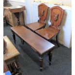 A mahogany rectangular window bench and matching pair of hall chairs each with a painted lions