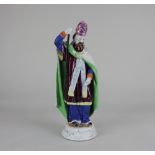 A Staffordshire pottery figure of Saint Patrick 24.5cm high