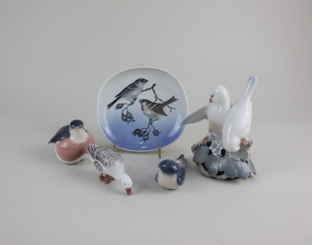 Four Royal Copenhagen porcelain models of birds to include a figure group of two doves 13.5cm,