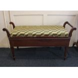 A rectangular mahogany piano stool, with upholstered rising top, width 109cm, height 59cm (a/f)