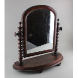 A Victorian dressing table mirror arched glass on bobbin turned supports and curved base width 51cm,