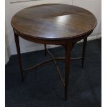 An Edwardian mahogany occasional table, with circular crossbanded top on tapered legs united by X-