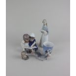 Three items of Royal Copenhagen porcelain comprising a model of two fish 4.5cm, an otter with fish
