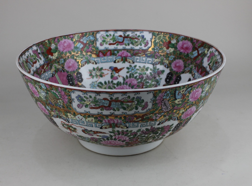 A 20th century Chinese famille rose porcelain bowl decorated with panels of figures and blossom,