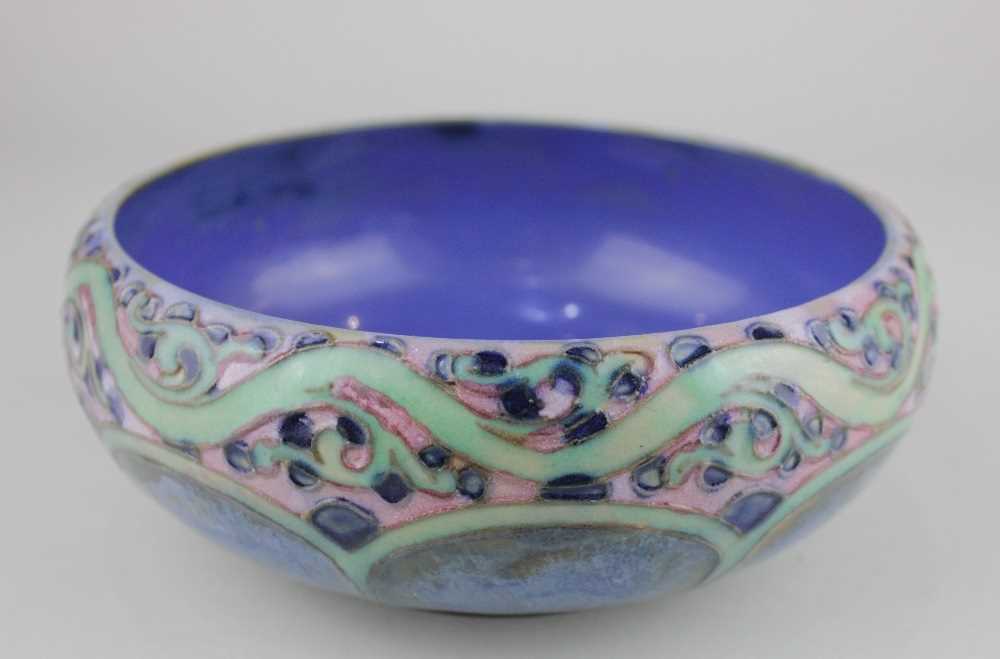 A Royal Doulton blue glazed bowl with tube lined foliate decoration 16cm diameter