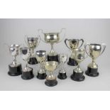 A collection of ten various silver plated trophies on plinths tallest 25.5cm