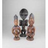 A pair of African, possibly Nigerian, carved wooden figures 30cm, and another figure 34cm
