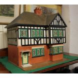 A two storey doll's house with hinged facade 71cm high, together with a collection of accessories to