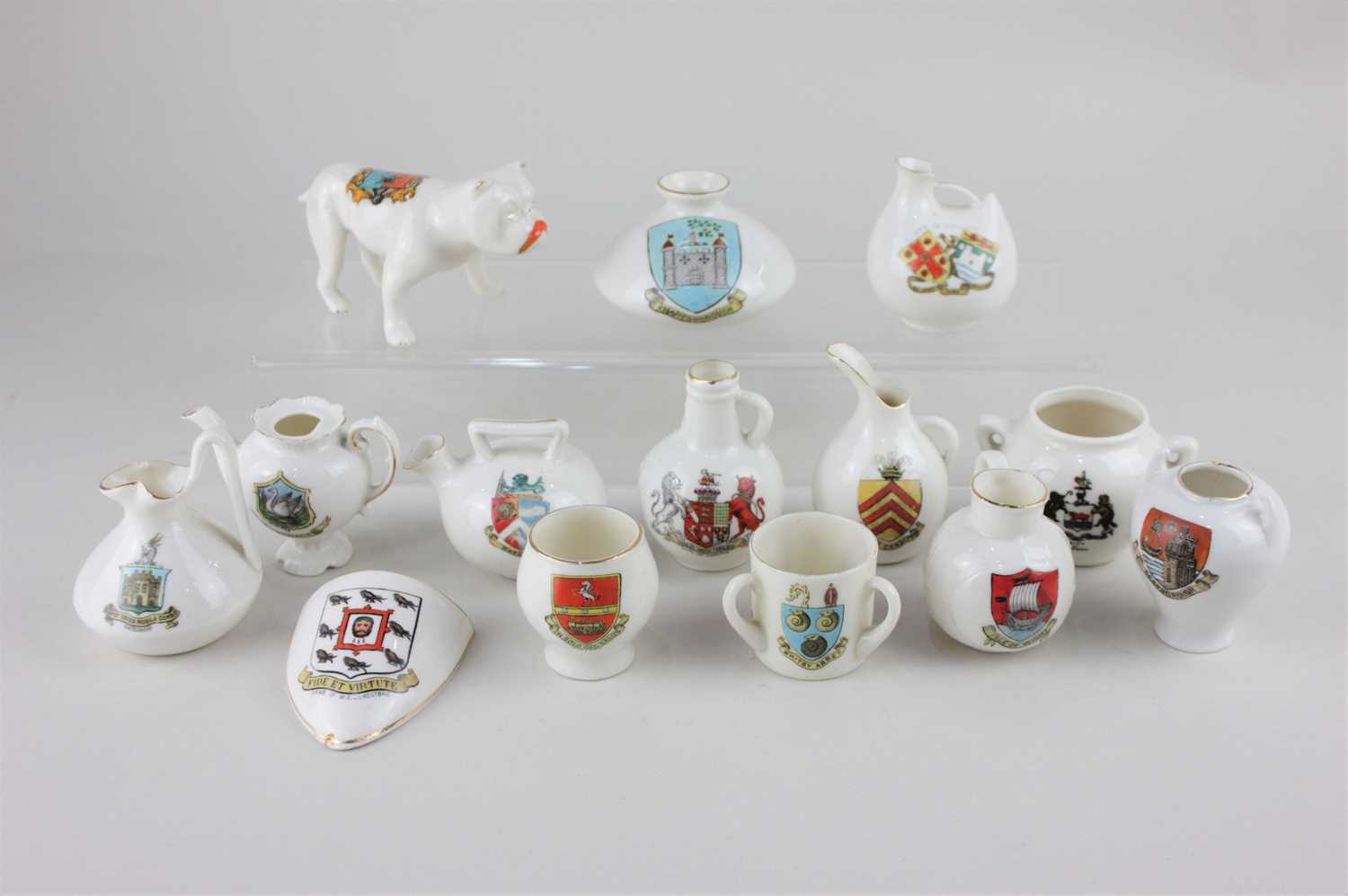 A collection of crested ware porcelain ornaments to include a W H Goss model of an Old Welsh