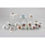 A collection of crested ware porcelain ornaments to include a W H Goss model of an Old Welsh