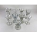 A collection of nine drinking glasses to include a penny lick and toasting glasses,