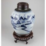 A Chinese blue and white porcelain ginger jar decorated with buildings and figures in a landscape