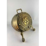 A brass barrel shaped coal scuttle embossed cover decorated with fruit, on claw feet