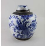 A Chinese blue and white ginger jar and cover, decorated with a bird amongst flowers, character