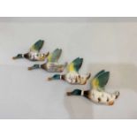 A set of four ceramic flying mallard duck wall plaques marked England 5/5, largest 11cm high