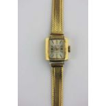 An Avia gold rectangular cased lady's wristwatch, the signed silvered dial with gilt baton hour