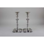 A pair of George II silver candlesticks baluster shape with removable drip pans, knopped stem,