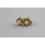 A pair of 18ct gold diamond and cultured pearl ear clips, each in a beaded and floral form design,