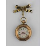 A gold cased keyless wind open face lady's fob watch with an unsigned gilt jewelled cylinder