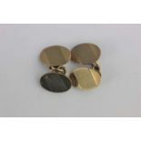 A pair of 9ct gold cufflinks the oval backs and fronts with engine turned decoration, Birmingham