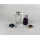 An Edward VII silver mounted glass scent bottle, Birmingham 1902, a white metal mounted amethyst