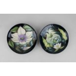 Two Moorcroft pottery pin dishes decorated with a passion flower 12cm diameter and a pond 11.7cm