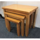 An oak nest of three occasional tables with rectangular top on square tapered legs 61cm