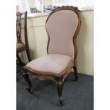 A Victorian upholstered nursing chair with scroll carved waisted back, lilac woven upholstery on