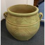 A large ceramic garden pot cauldron shape in green, width 73cm height 59cm