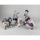 Four various 19th century porcelain figures to include a gentleman in a green tunic and purple