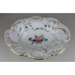 A Meissen porcelain oval dish decorated with a central bouquet of flowers within a pirced scroll