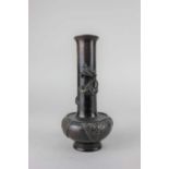 A Japanese small bronze vase with dragon applied to slender neck, above compressed body on