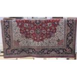 A Persian type carpet, red ground, with floral decoration, signature to one corner, approx 377cm