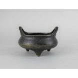 A Chinese bronze censor with two handles, seal mark to base 13cm