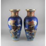 A pair of Satsuma ware baluster vases decorated with birds amongst flowers on blue ground, with gilt