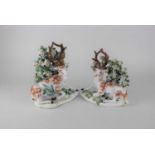 A pair of Staffordshire figures of a stag and deer seated with floral bocage, 22cm (a/f)