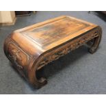 A Chinese carved opium / low table, pierced frieze with fruting vine decoration, on curved bracket