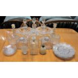 A collection of glass tableware to include a set of three candlesticks, pair of comports, jars,