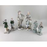 A pair of Dresden porcelain figures in floral costumes 25cm pair of Sitzendorf figures in green