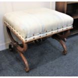 A Victorian rectangular upholstered stool with rising seat enclosing lined interior box on X