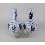 Two Chinese inside glass painted snuff bottles 10cm high together with a pair of blue and white